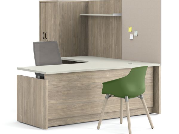 Contemporary U-shaped office workstation with overhead storage cabinet, privacy panel, mesh task chair, and green guest chair.