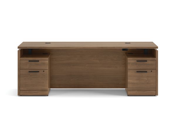 Double pedestal executive desk with woodgrain finish, integrated power access, and built-in file storage.