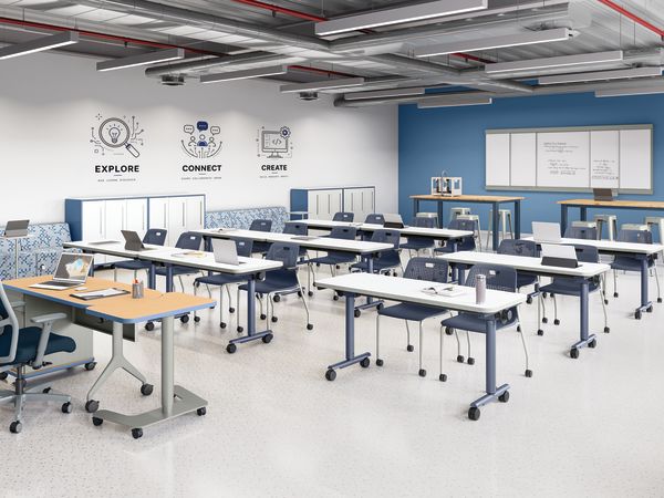 Flexible learning classroom with mobile student desks, rolling chairs, instructor workstation, whiteboards, collaborative seating, storage cabinets, and technology-ready workspace in a modern educational environment.