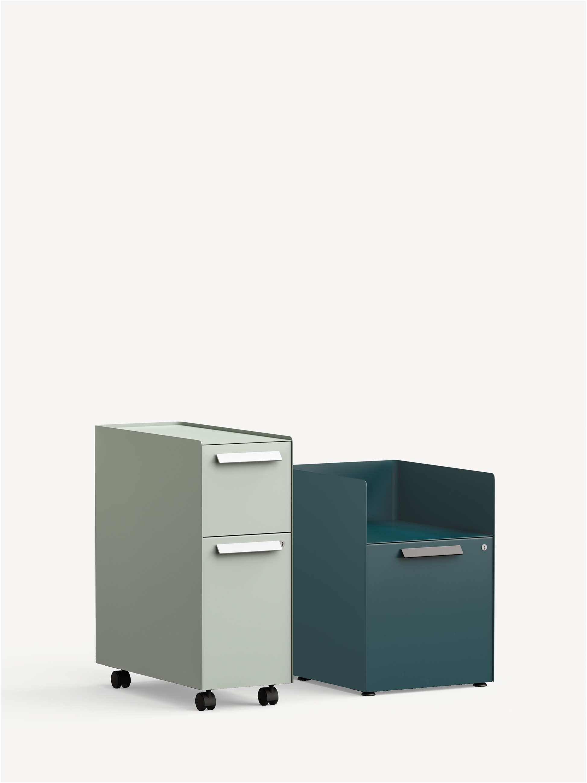 Three-quarter view of a Radii Slim Pedestal in light grey with one box drawer, one file drawer, bar pulls and casters next to a Radii Alcove pedestal in dark teal with glides, one file drawer and bar pulls.