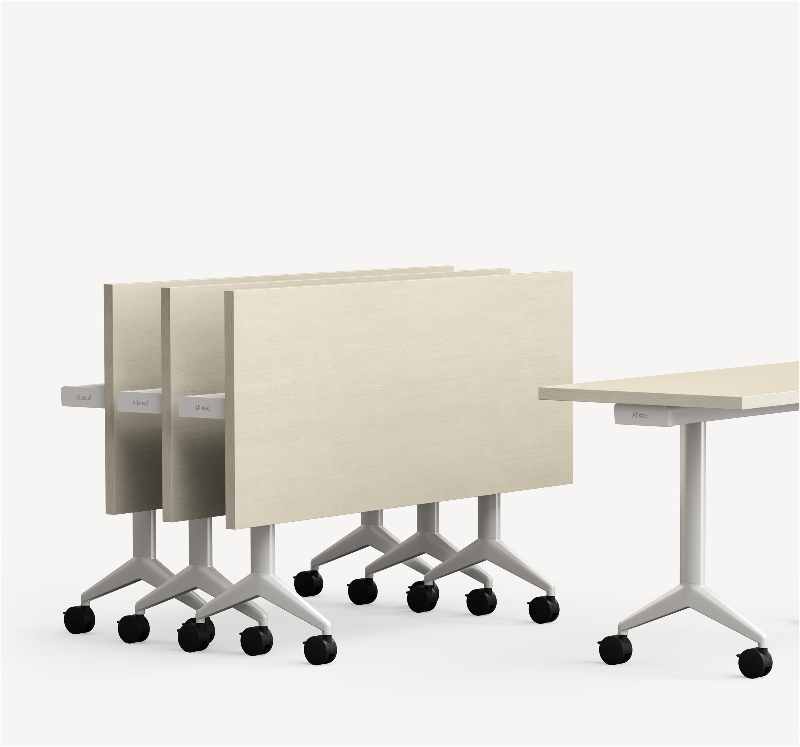 Three aware folded training tables with a nested V-leg and casters folded next to each other.