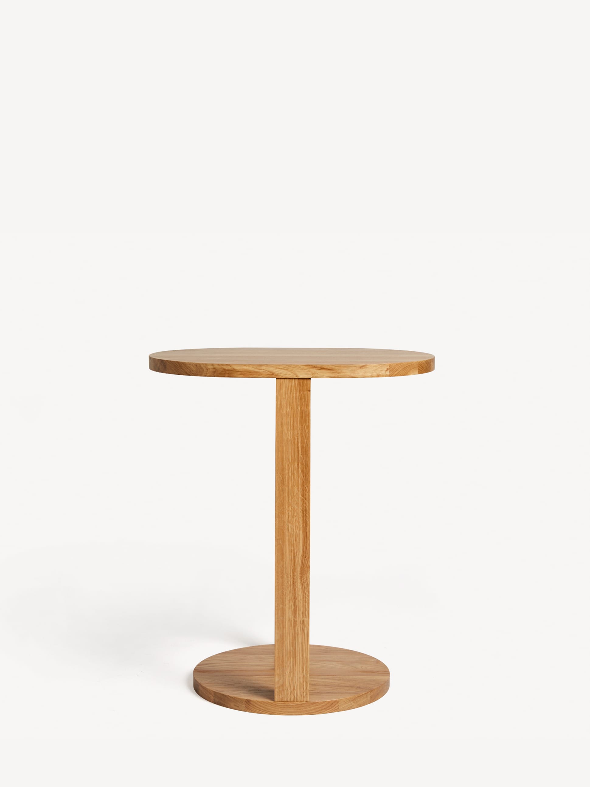 Unique Tuck side table in light oak with a round table top and split pedestal round base.