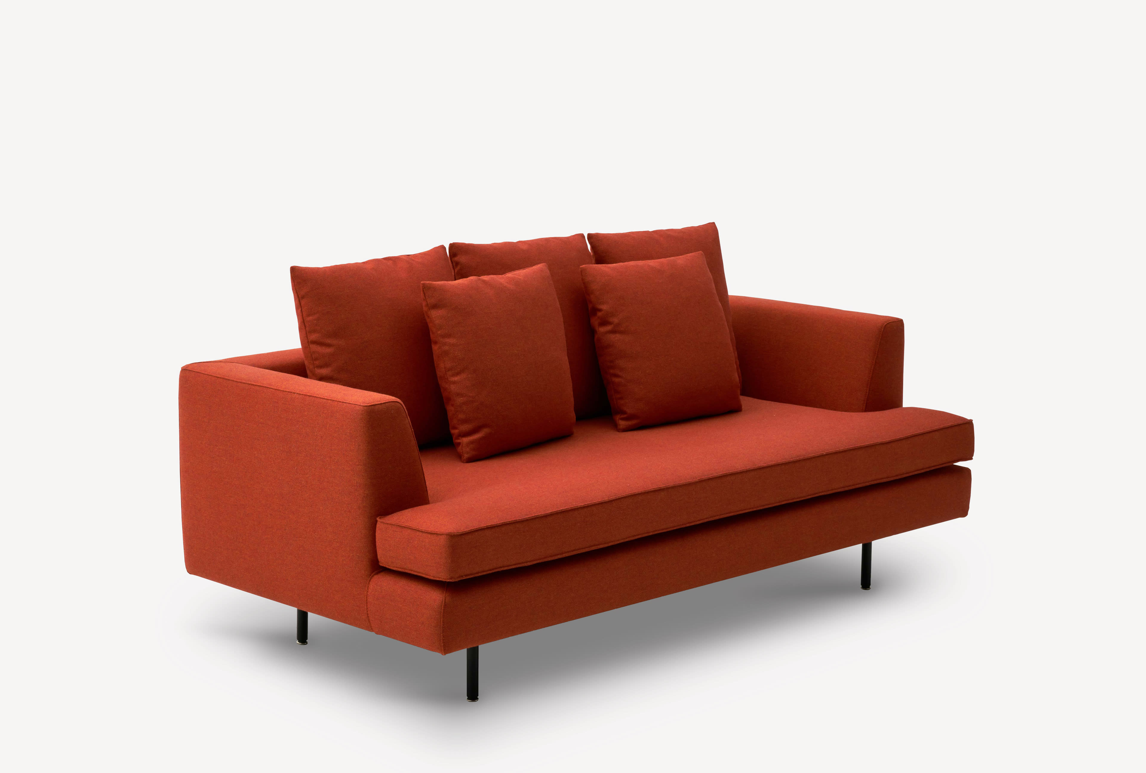 Three-quarter front view of the Corral Deck sofa with black legs and burnt orange upholstery.