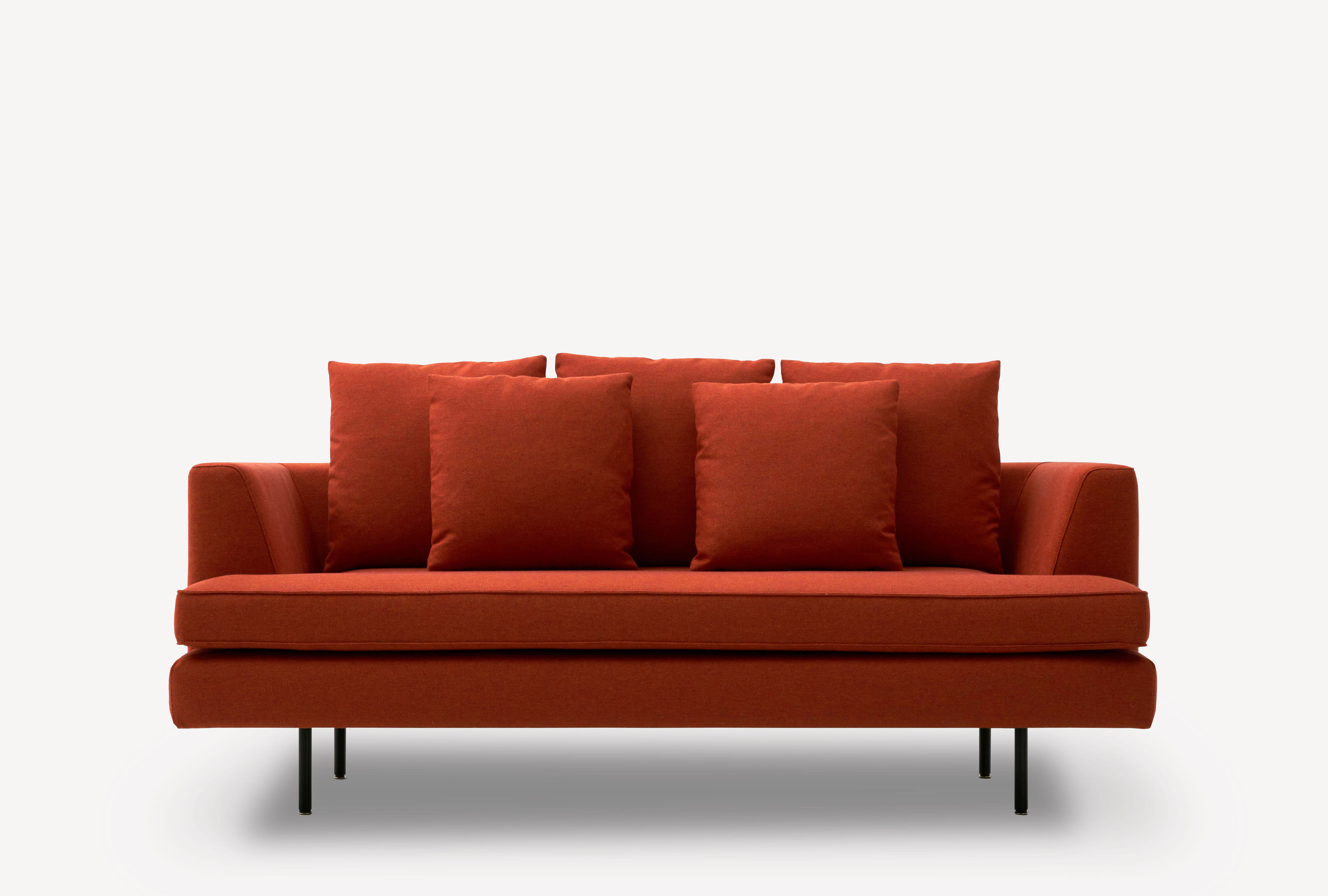 Front view of the Corral Deck sofa with black legs and burnt orange upholstery.