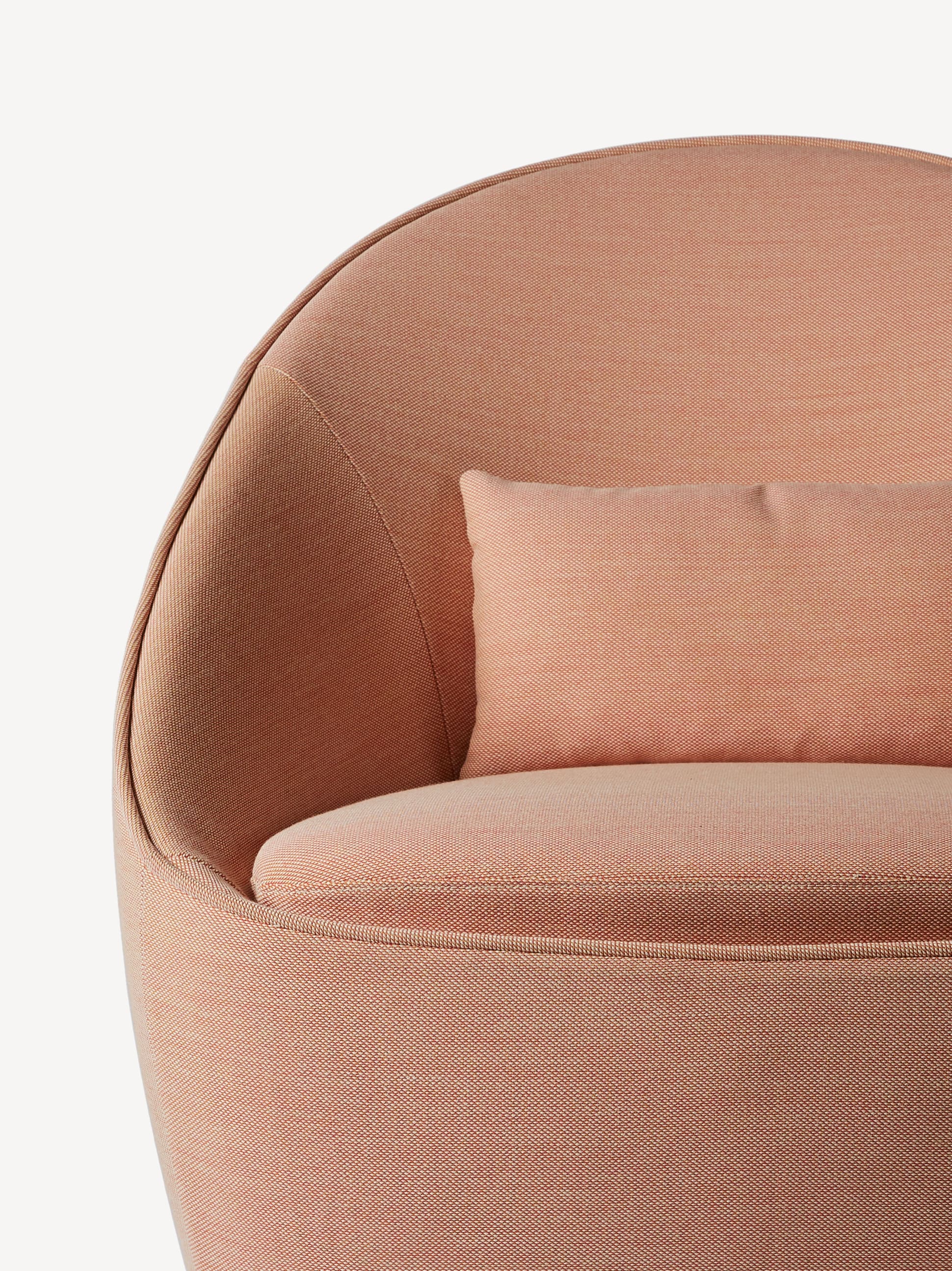 Close-up front view of the Corral Spin lounge chair in coral colored upholstery.