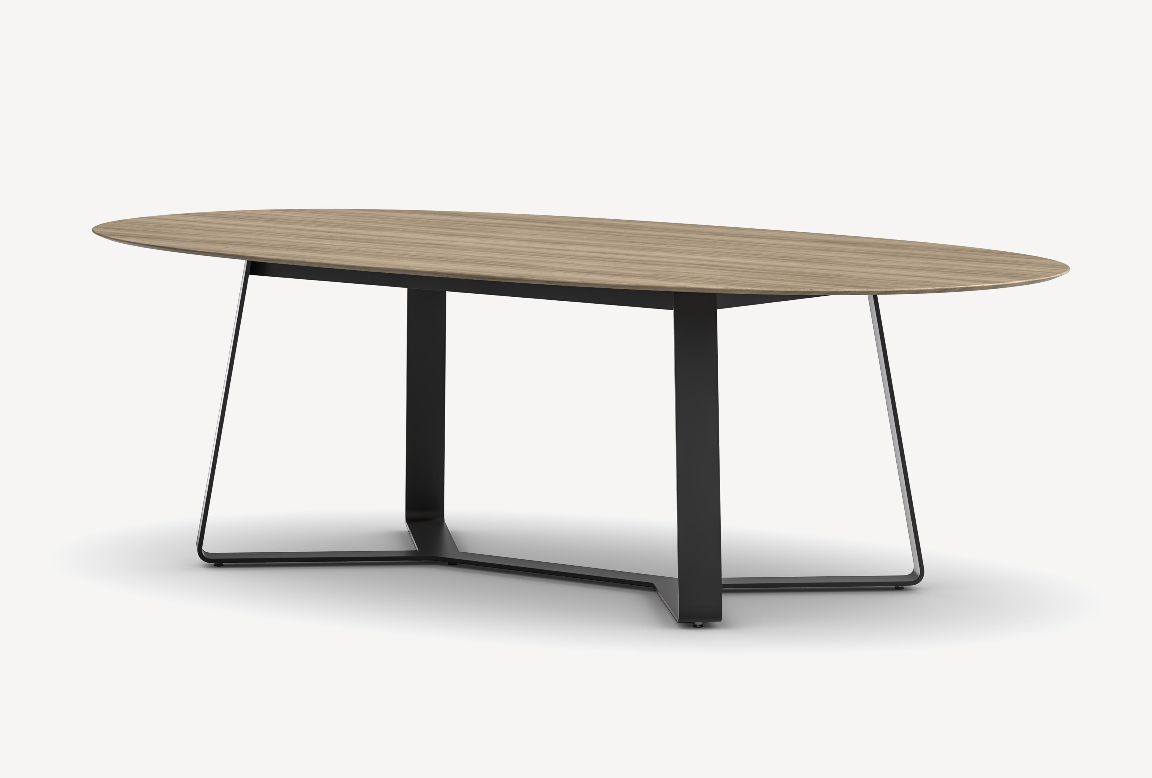 Three-quarter front view of a Gunlocke Briefing conference table with light wood ellipse top and black metal ribbon Y base.