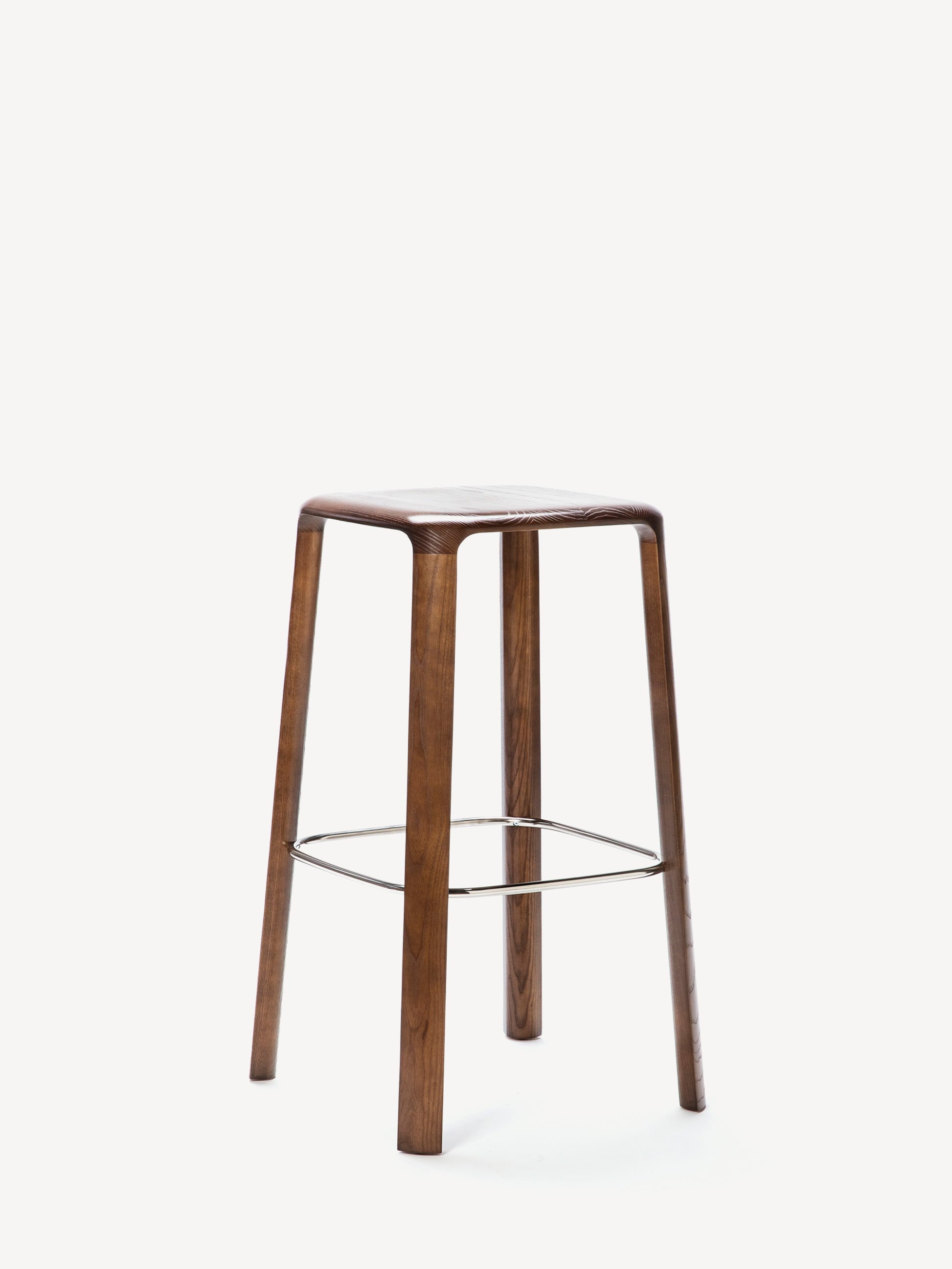 Three-quarter view of the Gunlocke counter-height Trillia stool with a dark wood base, silver footrest and wood seat.