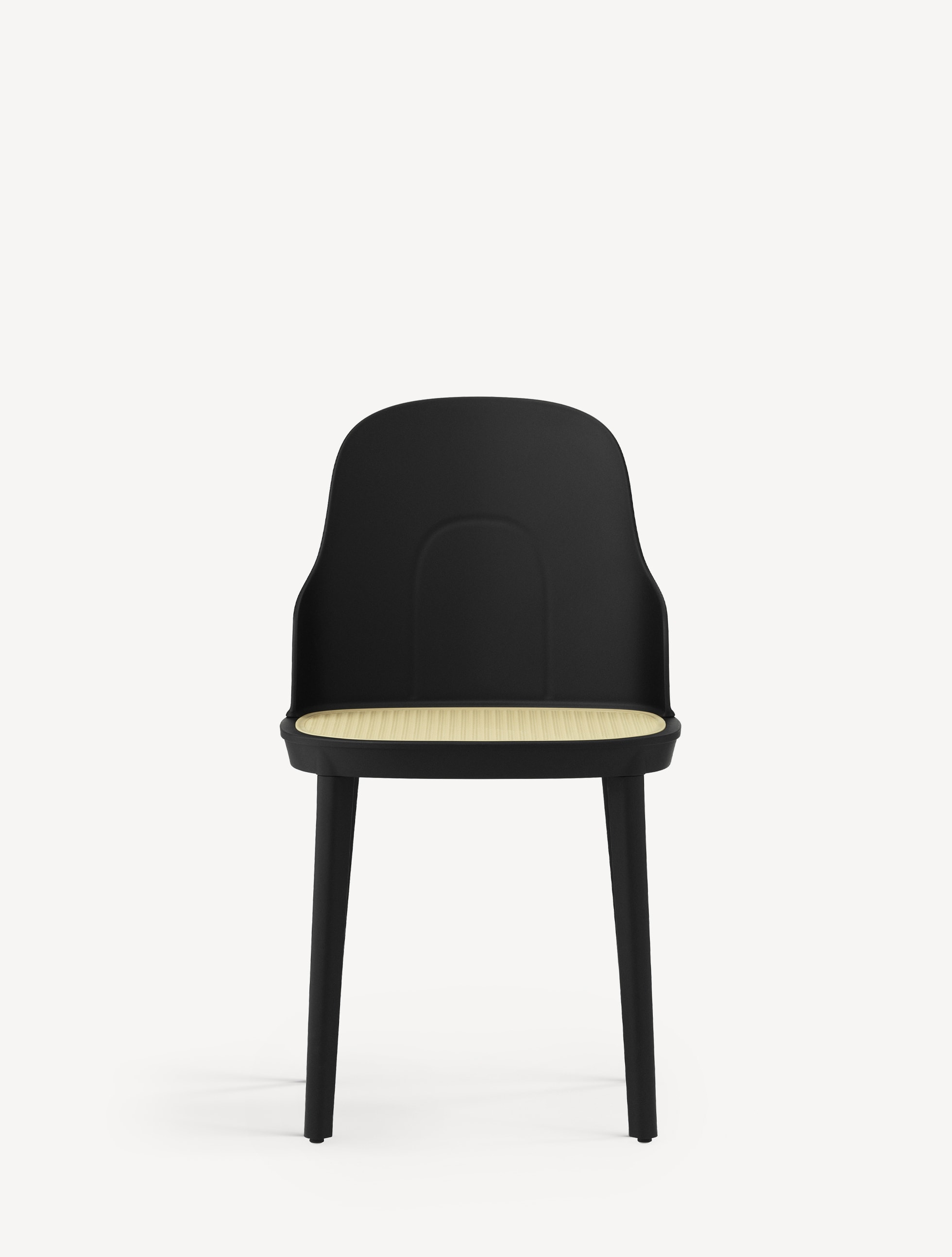 Front view of the Normann Copenhagen Allez Chair with molded wicker seat and black base and shell.