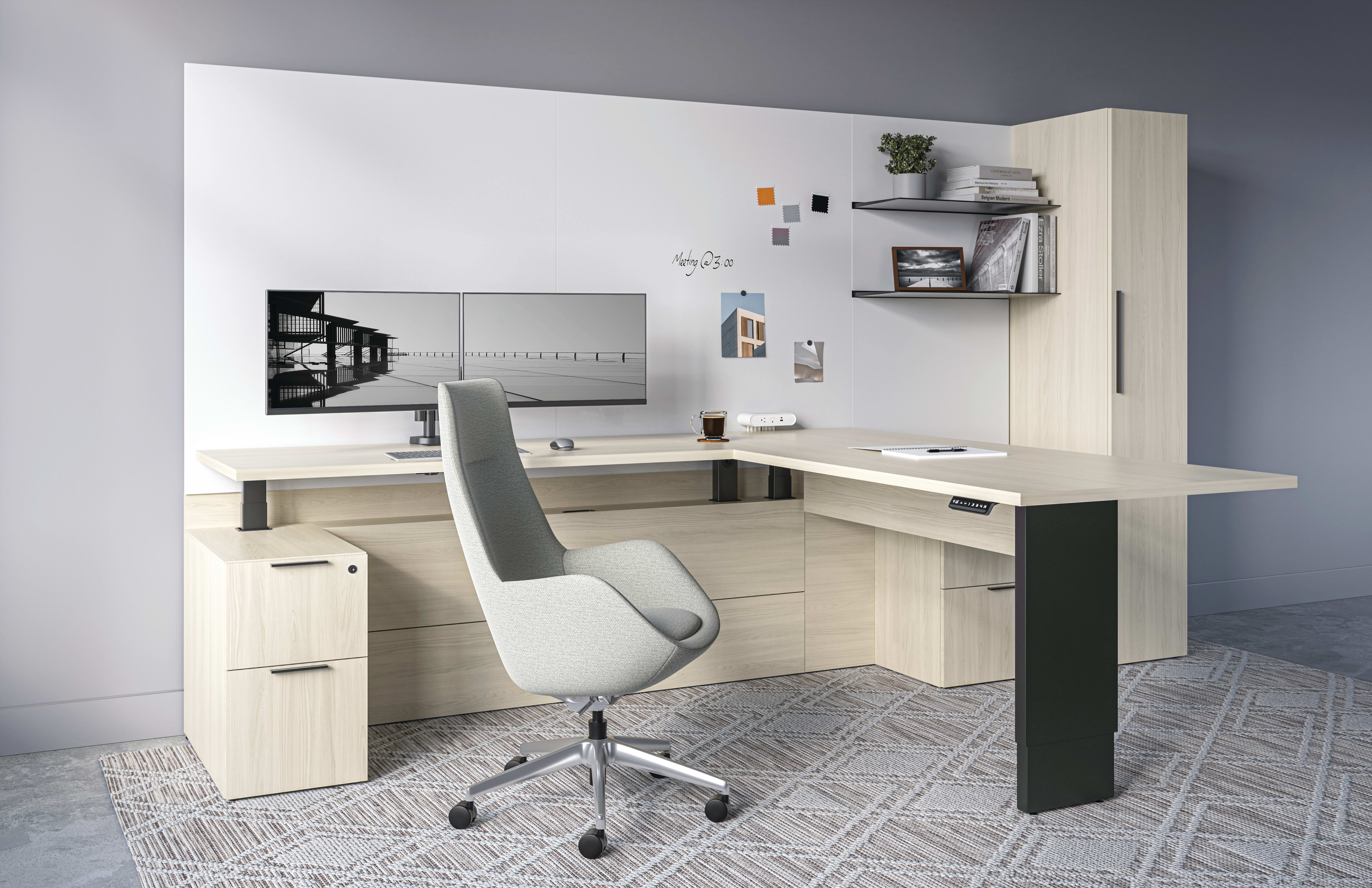 Private office of light woodgrain Silea desking with a Height-adjustable L-shaped return below a whiteboard wall with a light grey Retreat Executive Height chair.