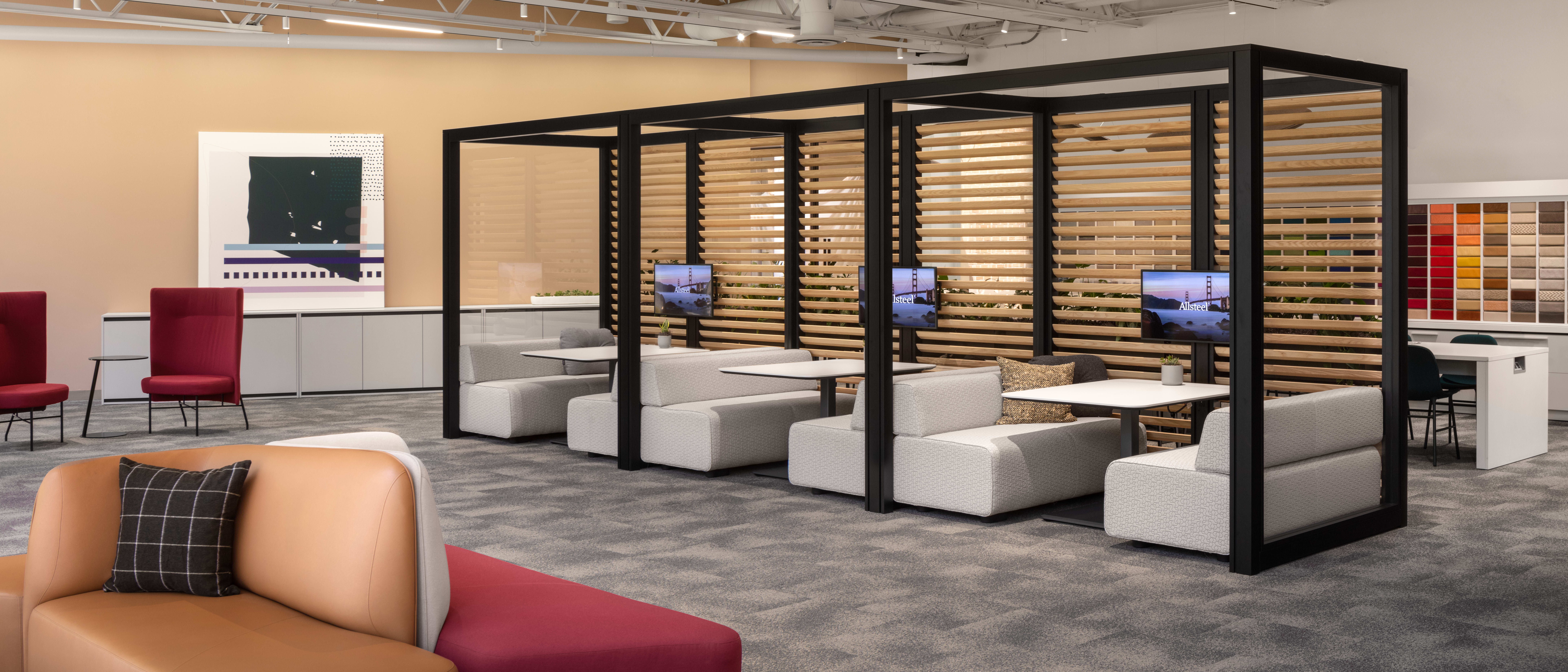 Open office commons with booth seating, technology, and lounge seating.