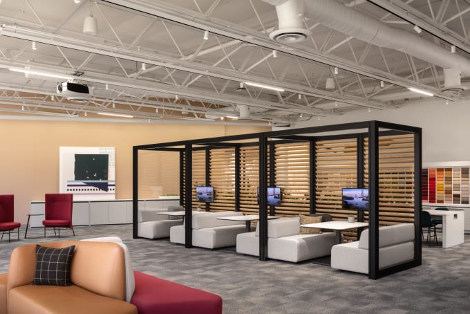 Open office commons with booth seating, technology, and lounge seating.