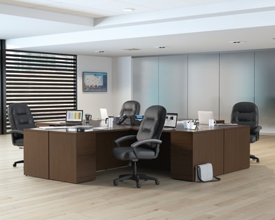 A modern and minimalist office space with wooden desks, black office chairs, and a striped partition wall in the background.