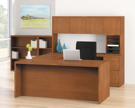 A modern and minimalist home office setup with wooden furniture, including a desk, shelves, and cabinets, against a bright and airy background.