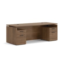 Double pedestal executive desk with woodgrain finish, integrated power access, and built-in file storage.