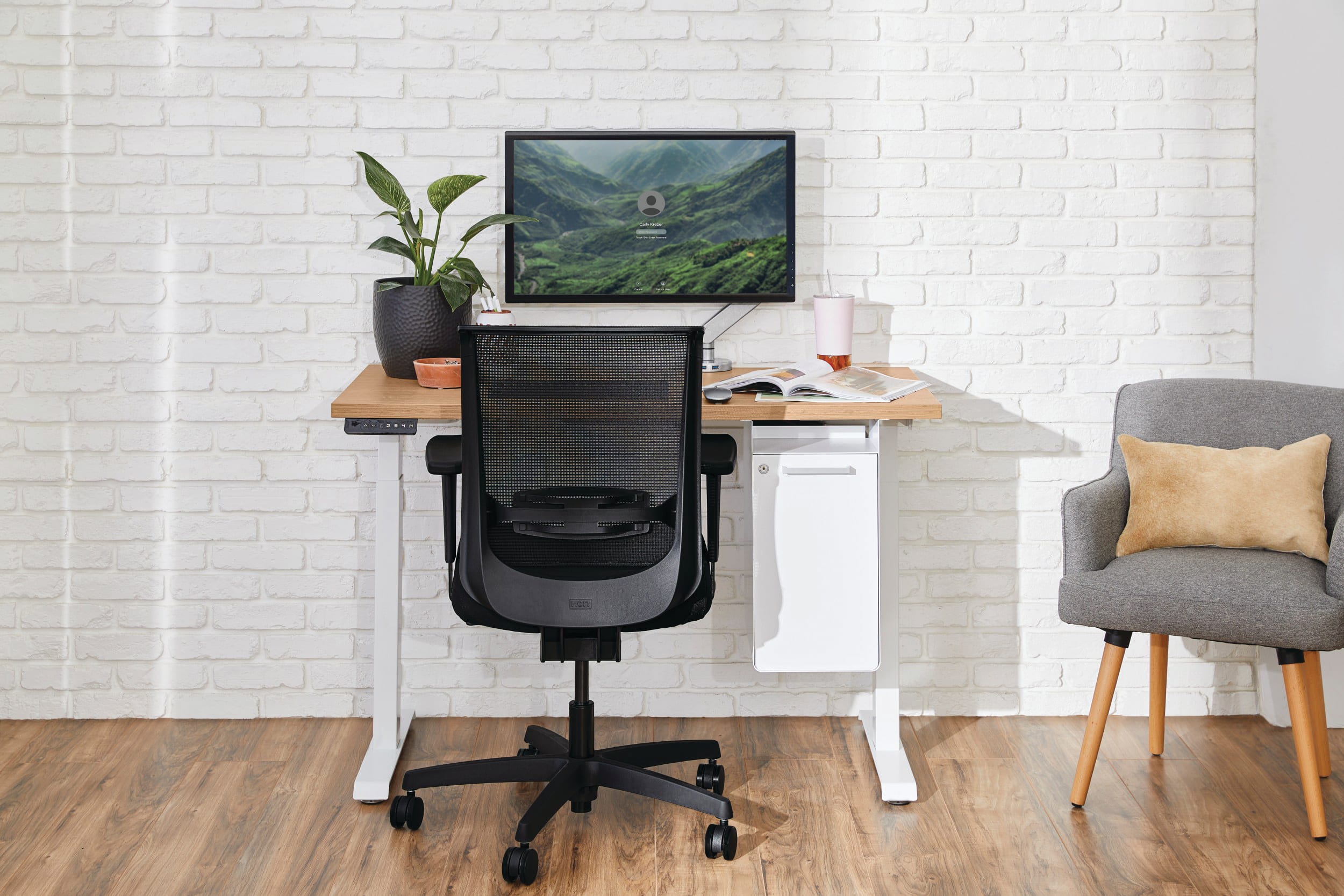 Two white Coordinate Height-Adjustable Bases paired with Coze desk tops and Convergence Task chairs in a small office setting