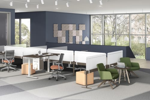 A modern and minimalist office space with workstations, chairs, and large windows overlooking a natural outdoor environment.
