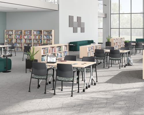 A multi-media center setting featuring SoCo seating, Ignition guest chairs, and Motivate tables.