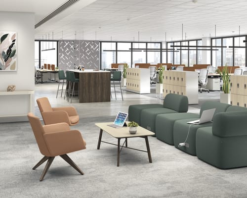 A modern and open-concept office space with comfortable seating areas, workstations, and large windows providing ample natural light.