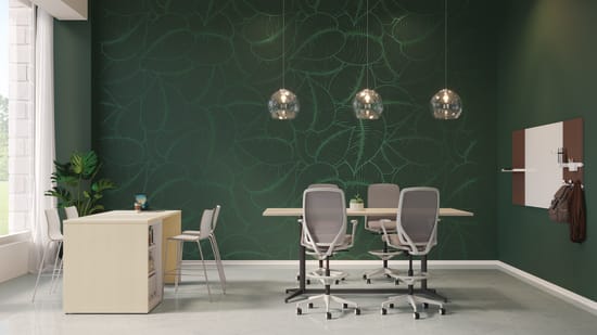 A modern and minimalist office space with a green accent wall, white furniture, and three hanging pendant lights.