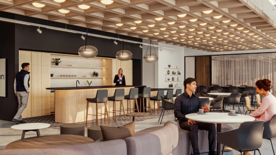 Cafe seating area with round table, molded plastic chairs, bar-height stools, and upholstered lounge seating with low tables.