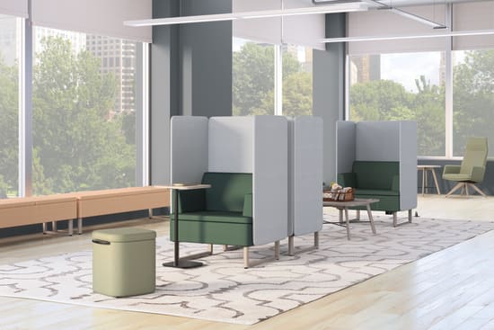 A modern and minimalist office space with sleek furniture, large windows providing natural light, and a patterned rug on the floor.