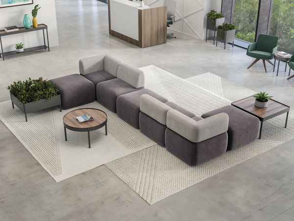 SoCo multi-fabric modular lounge in reception area with Sculpt occasional tables & planters near 10500 Series station and Mav seating.