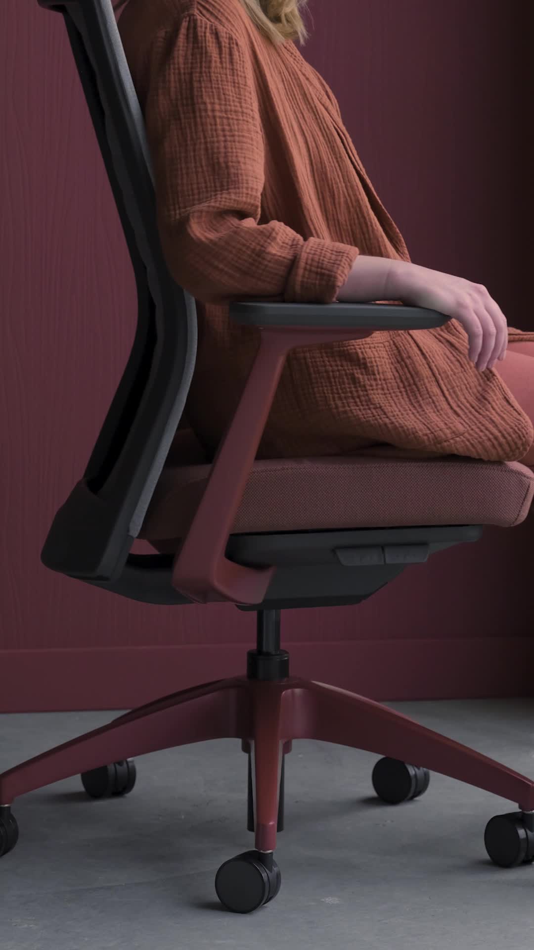 Video of a person turning in a gray and red Allsteel Evo Task Chair in a red room
