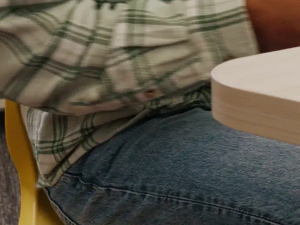 Vertical 9 x 16 video of students and a teacher at Field Trip tables showing details of purple and yellow Smartlink chairs and a purple Flock pouf in a Multi-media Center with Storyline bookcases.