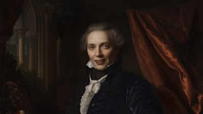 A person in elegant 18th-century attire, featuring a blue velvet coat and white ruffled shirt, stands beside a table with a white rose and goblet.