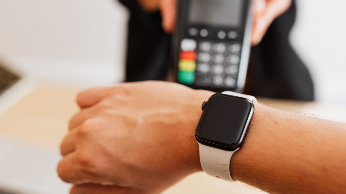 Priority Technology to go private in $1.6 billion deal Person making a contactless payment using a smartwatch at a cashless checkout counter.