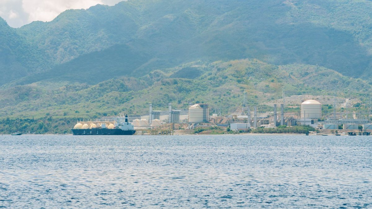 Afreximbank and ATDC launch $500m trade fund Scenic view of industrial facility and large ship against mountainous backdrop.