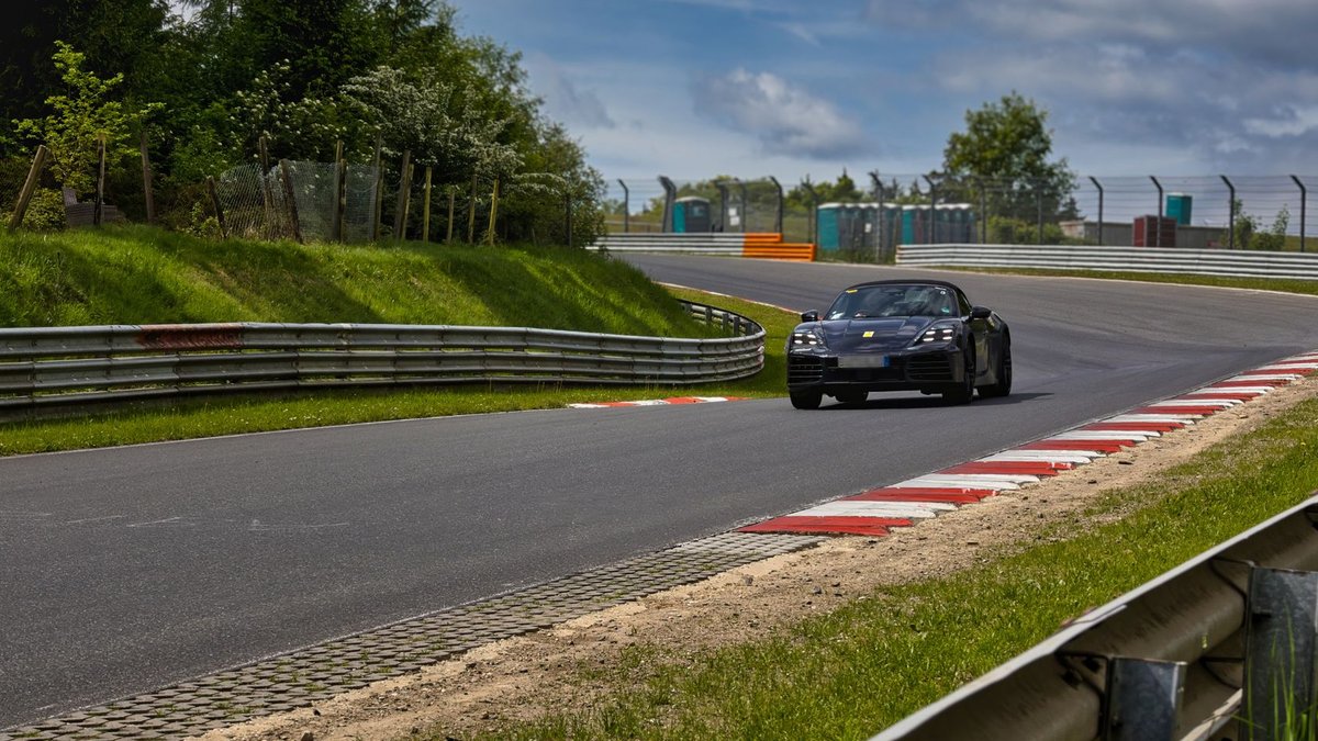 A sleek sports car races around the Nürburgring Nordschleife, capturing the thrill of motorsport.