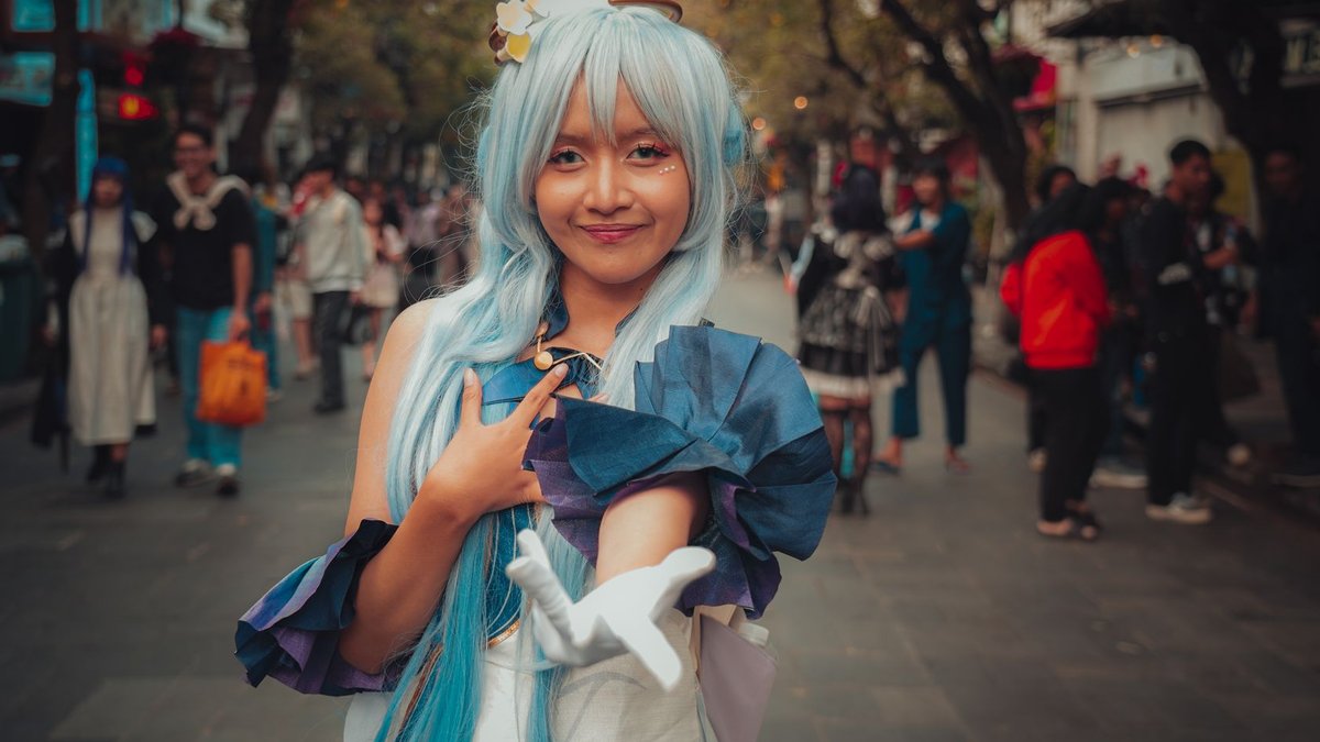 HR leader emphasizes integrity and courage A young woman in colorful cosplay attire poses confidently on a bustling street, surrounded by people.