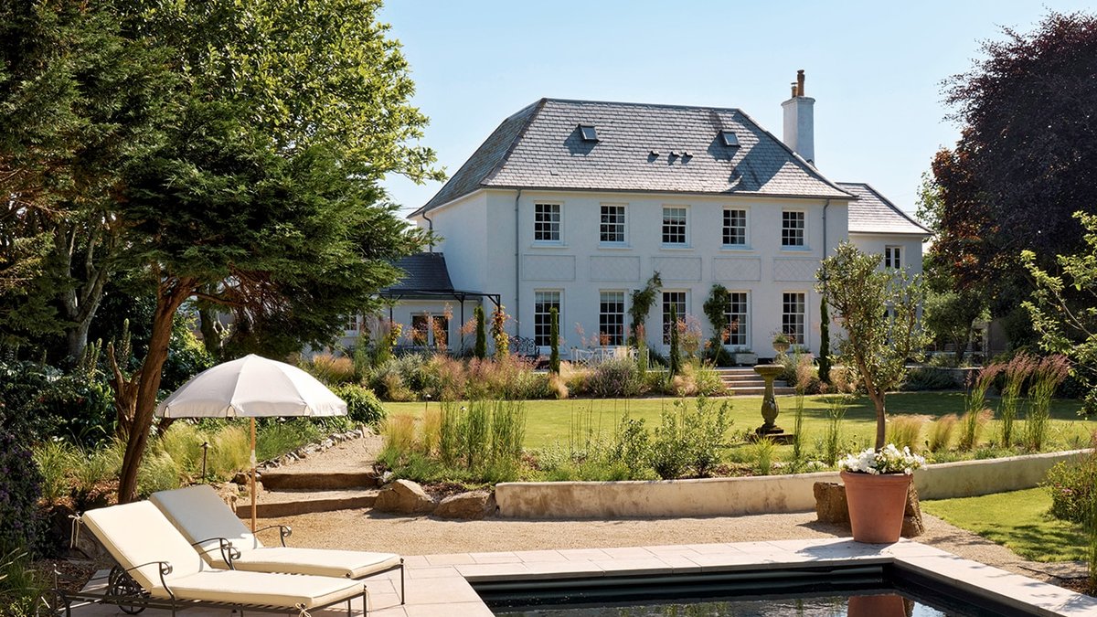 Sun loungers from Neptune and an umbrella from Zara Home create an idyllic spot to unwind in the garden | Photo.