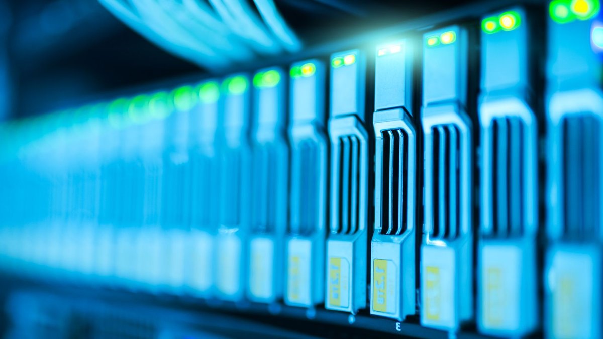 India's Tech Sector Booms with AI, Semiconductor Growth Detailed image of a server rack with glowing lights in a modern data center.