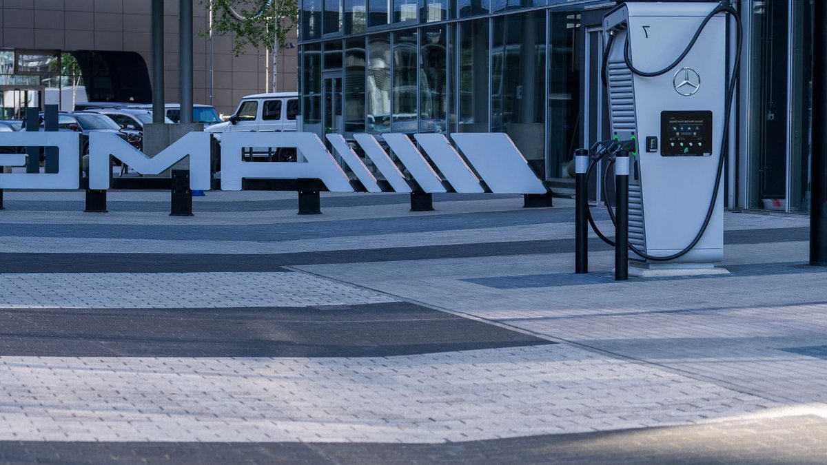Electric vehicle charging station at a modern business complex featuring sleek architectural design.