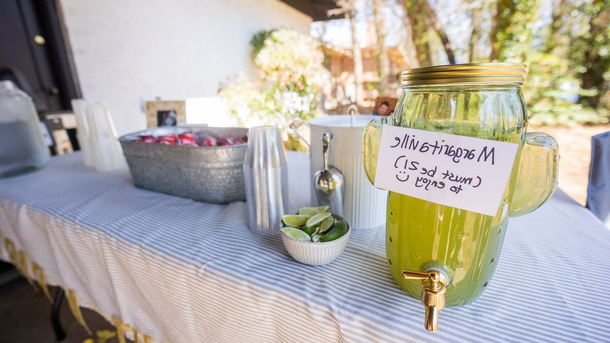 Chipotle brings back margaritas in five cities Refreshing outdoor margarita bar setup with lime and cocktail essentials.
