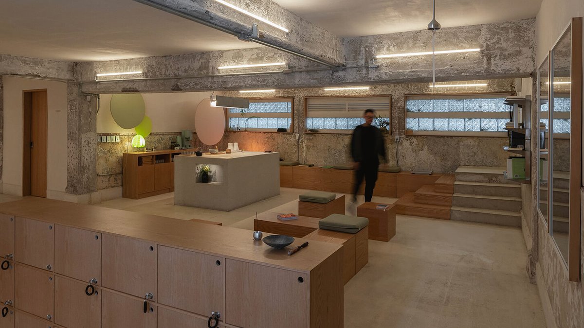 Mexico City bar focuses on sound experience Modern, industrial-style interior with open seating, wooden lockers, a central island, and exposed concrete walls—reminiscent