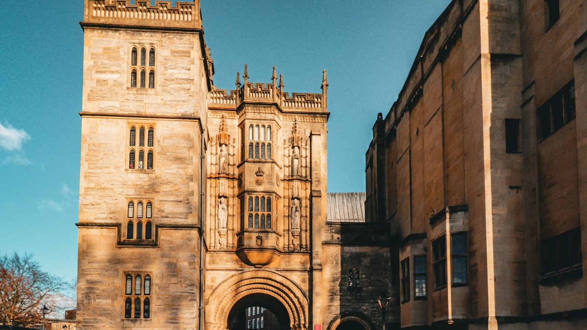 Beautiful view of historical building with intricate architecture in Bristol under clear blue sky.
