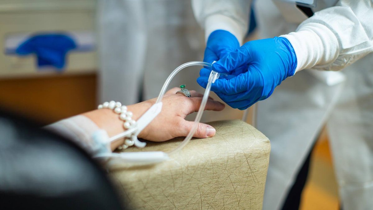 Chemotherapy drug being administered intravenously by a nurse.