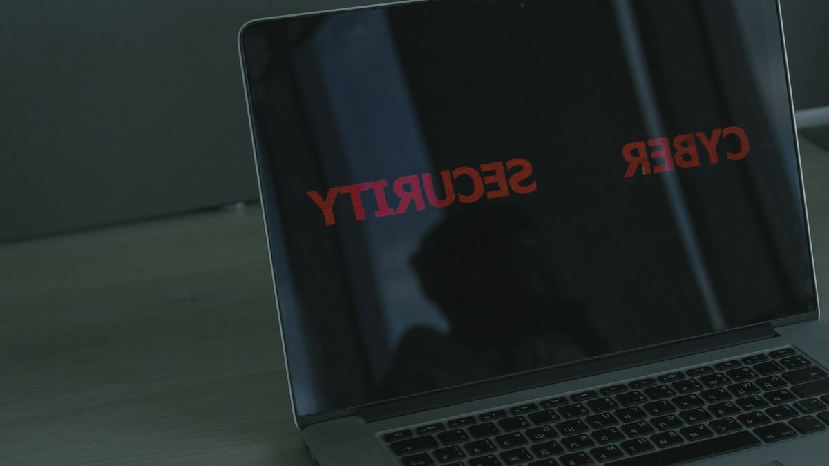 Close-up of a laptop displaying cybersecurity text, emphasizing digital security themes.