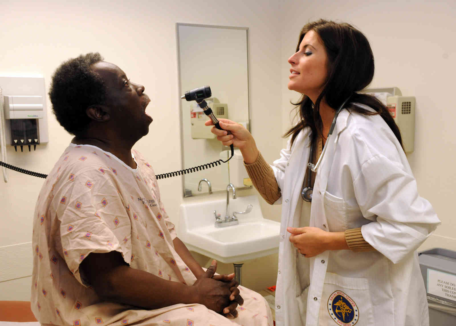 A photo of a medical professional examining a patient.