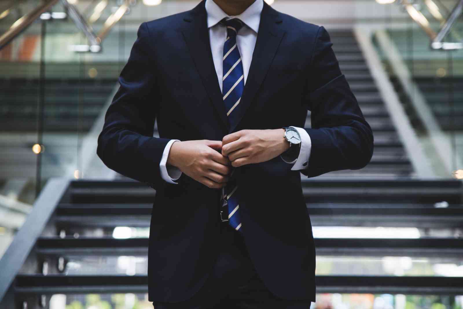 Man in front of stairs wearing a suit