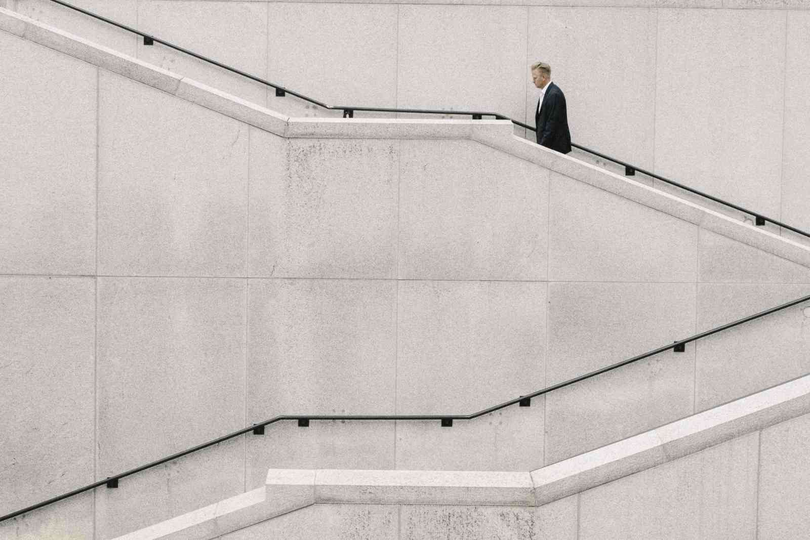 Man in suit walking up stairs