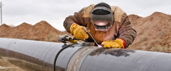 A welder working on a gas pipline.