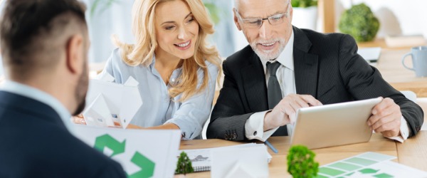 A sustainability officer discussing a project with his colleagues.