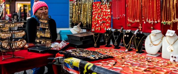 A street vendor sells food, goods and merchandise on the street or in an open-air market rather than at a traditional store.