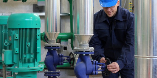 A pump operator monitoring a flowmeter.