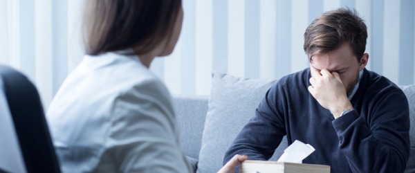 A psychiatrist sitting across from a patient.