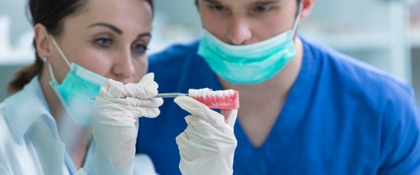 A prosthodontist looking at dentures.